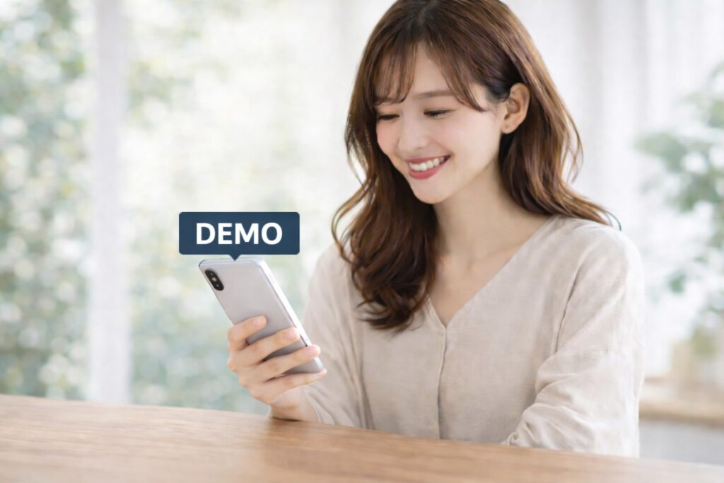 スマートフォンを持つ女性とデモ口座のロゴ